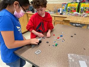 students discuss the design of their car